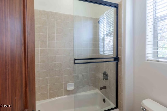 full bath with enclosed tub / shower combo and toilet