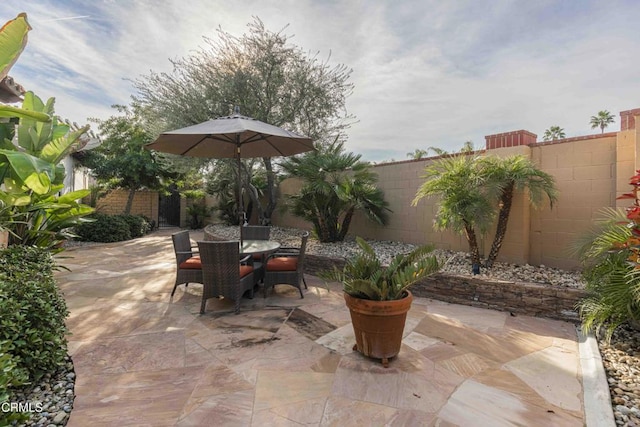 view of patio featuring outdoor dining space and a fenced backyard