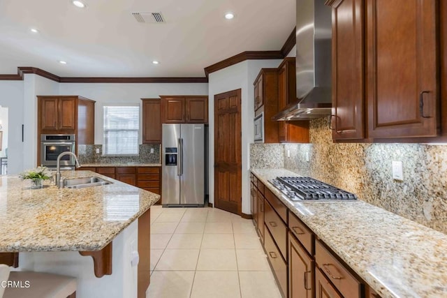 kitchen featuring light tile patterned floors, visible vents, a sink, appliances with stainless steel finishes, and wall chimney range hood