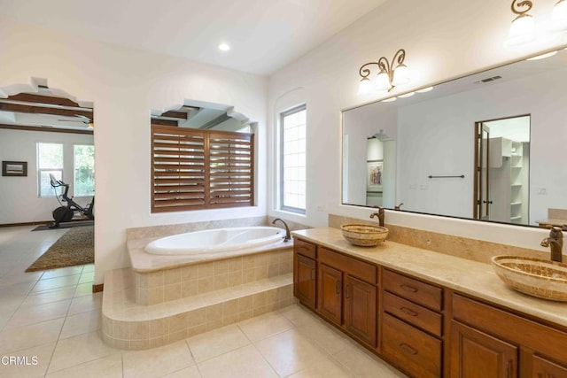 bathroom with a wealth of natural light, tile patterned floors, and a sink