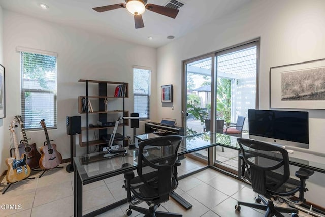 office space featuring light tile patterned flooring, visible vents, and ceiling fan