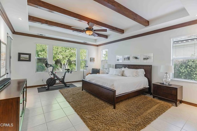 bedroom with a raised ceiling, multiple windows, and light tile patterned floors