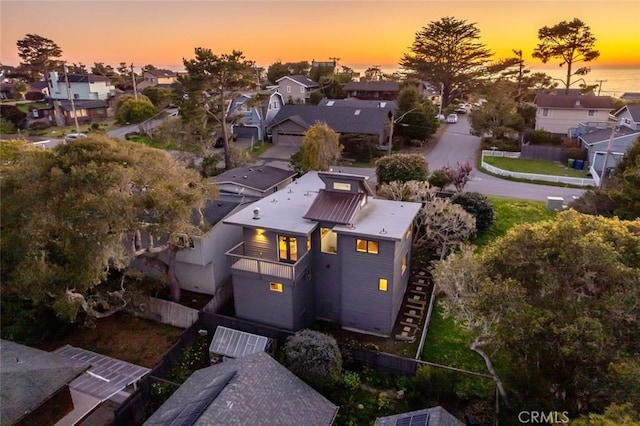 aerial view at dusk featuring a residential view