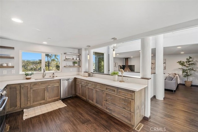 kitchen with open shelves, dark wood-type flooring, appliances with stainless steel finishes, and a sink