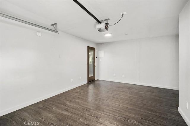 unfurnished room featuring baseboards and dark wood finished floors