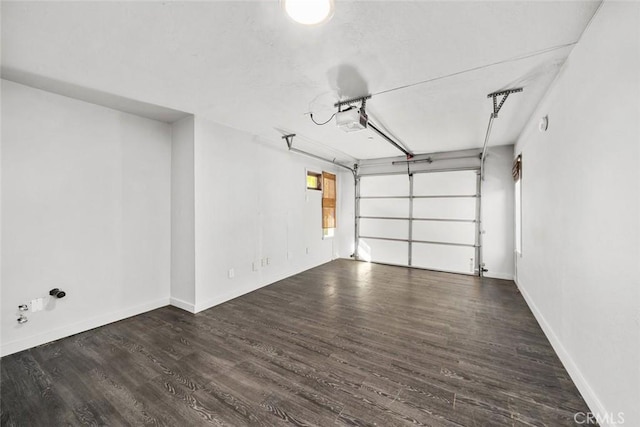 garage with a garage door opener and baseboards