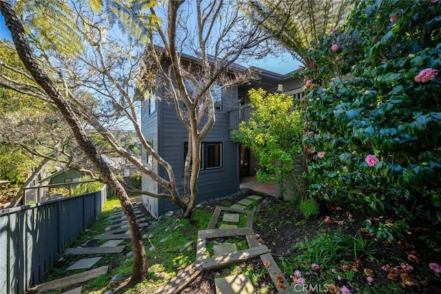 view of side of home with fence