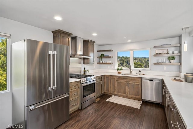 kitchen featuring a healthy amount of sunlight, open shelves, a sink, appliances with stainless steel finishes, and wall chimney exhaust hood