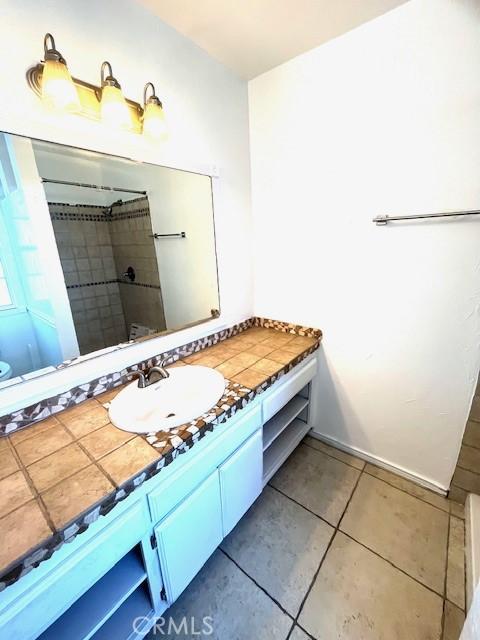 bathroom featuring vanity, tile patterned floors, and a shower with curtain