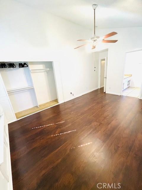 unfurnished living room with a ceiling fan and wood finished floors