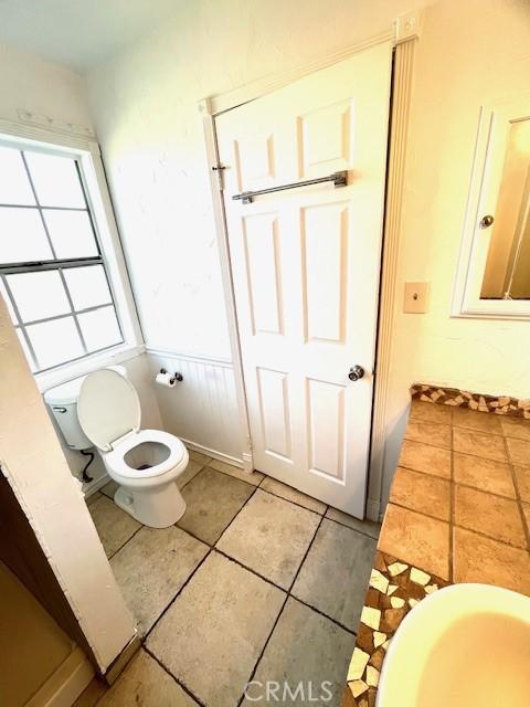 bathroom with tile patterned floors and toilet