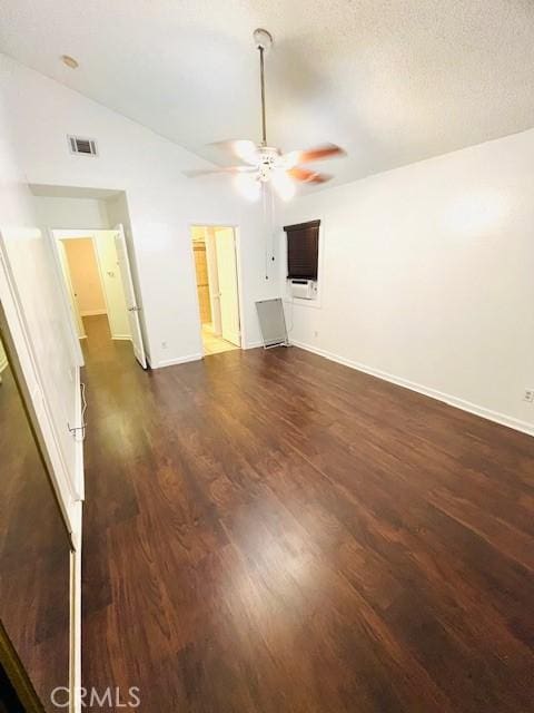 unfurnished living room featuring a ceiling fan, baseboards, visible vents, lofted ceiling, and dark wood-type flooring