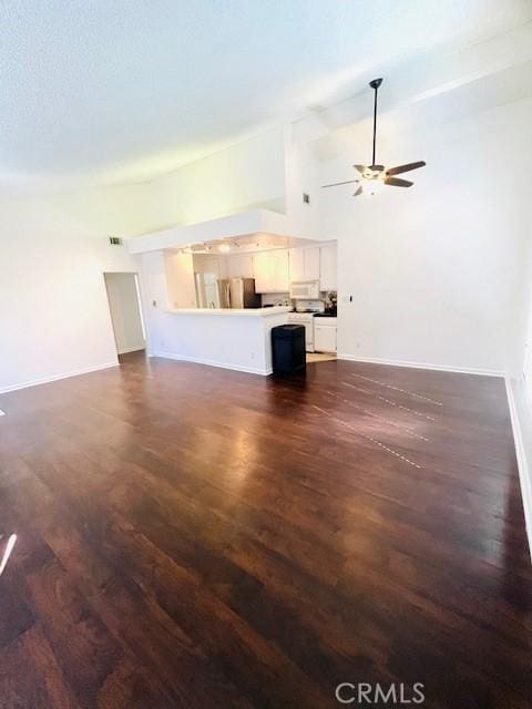 unfurnished living room featuring baseboards, dark wood-type flooring, and a ceiling fan