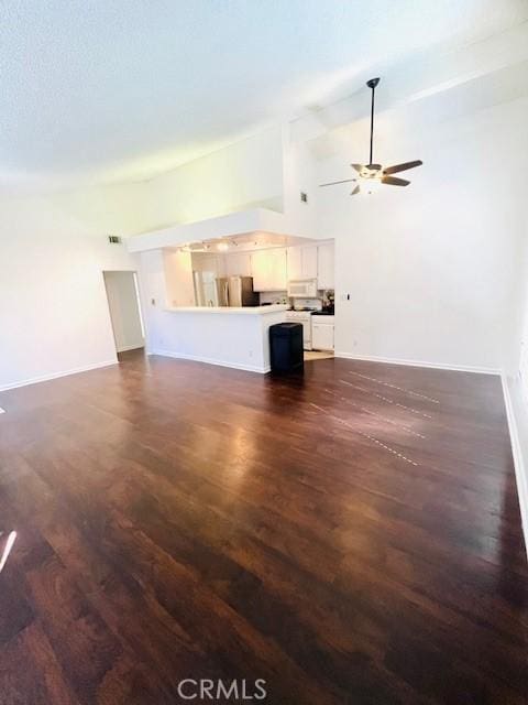 unfurnished living room with baseboards, ceiling fan, and dark wood finished floors