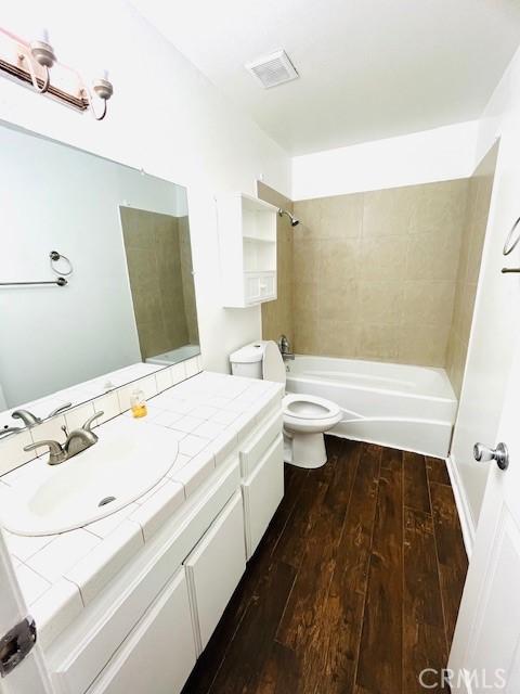 1864 Raymond Ave Unit 4, Signal Hill, CA 90755 - full bath featuring hardwood / wood-style floors, toilet, shower / bath combination, and vanity