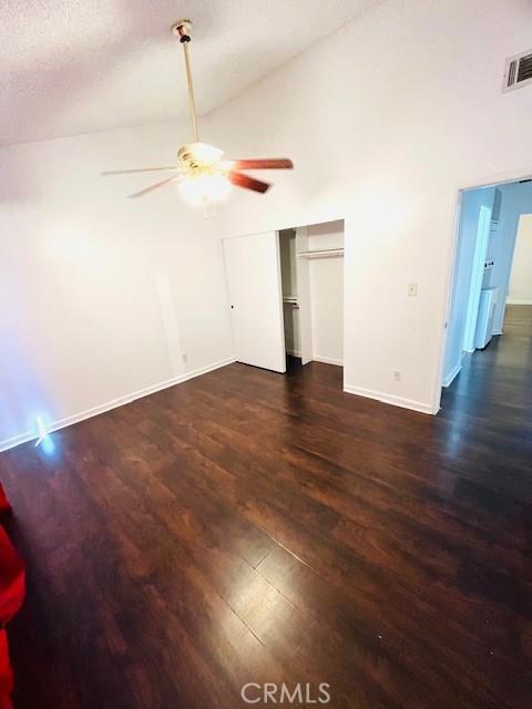 1864 Raymond Ave Unit 4, Signal Hill, CA 90755 - unfurnished living room featuring ceiling fan, wood finished floors, high vaulted ceiling, and baseboards
