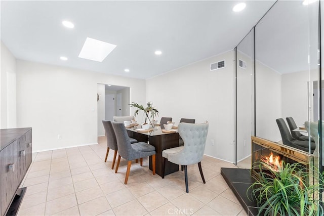 dining area with a skylight, light tile patterned flooring, recessed lighting, and visible vents