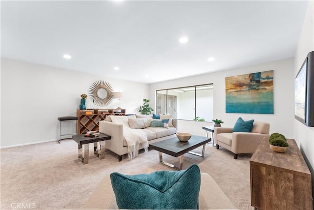 living room with recessed lighting, light colored carpet, and baseboards