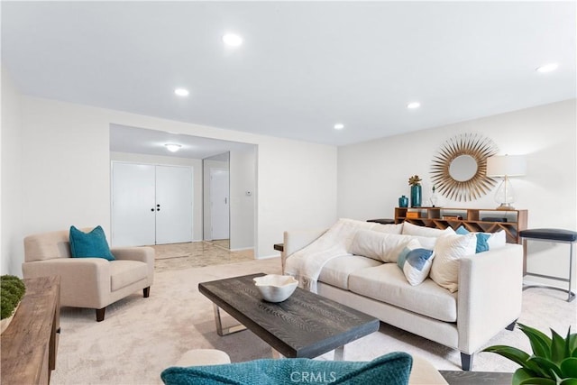 living area featuring light carpet, recessed lighting, and baseboards