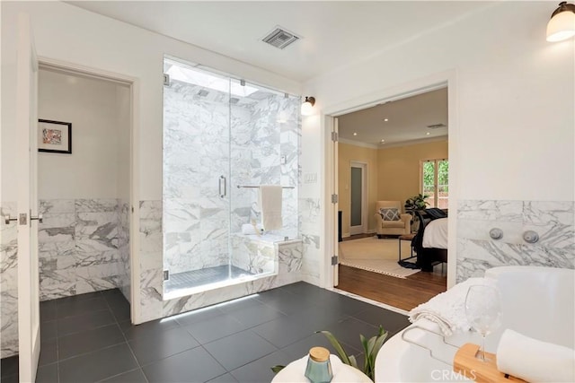 ensuite bathroom with visible vents, a marble finish shower, ensuite bathroom, tile walls, and a washtub