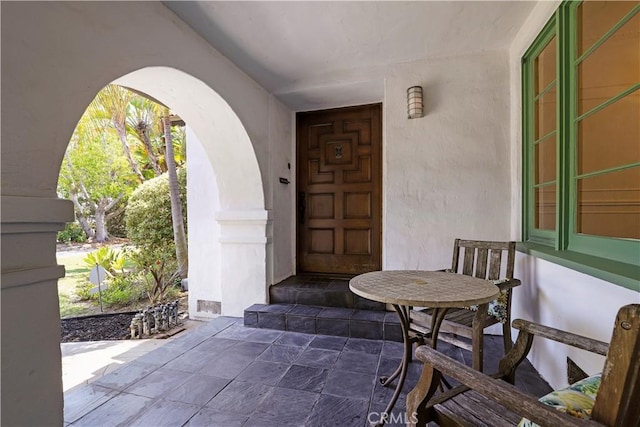 doorway to property featuring stucco siding
