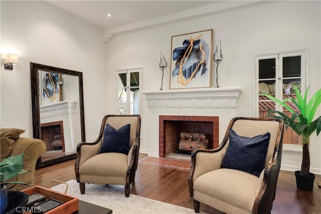 living room featuring recessed lighting, wood finished floors, and a fireplace