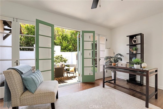 office area with a healthy amount of sunlight, french doors, ceiling fan, and wood finished floors
