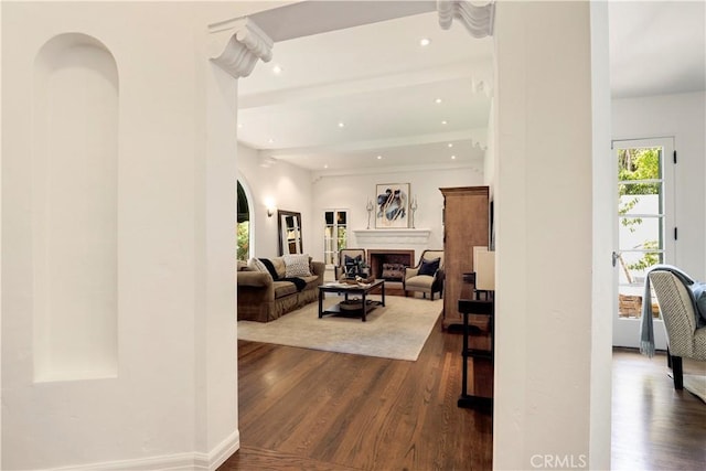 living area with recessed lighting, dark wood-style floors, and a fireplace