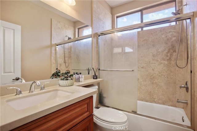 full bathroom with vanity, toilet, and enclosed tub / shower combo