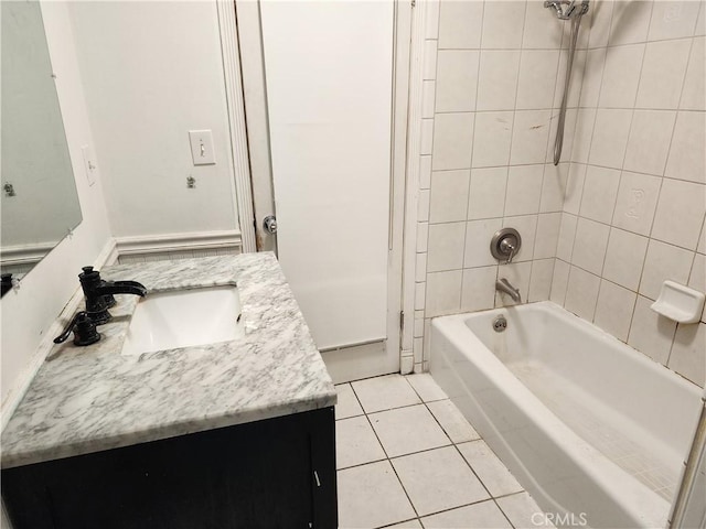 bathroom with tile patterned flooring, vanity, and shower / bath combination