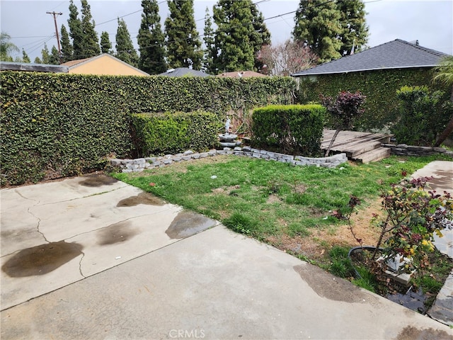 view of yard featuring a patio, fence, and a wooden deck