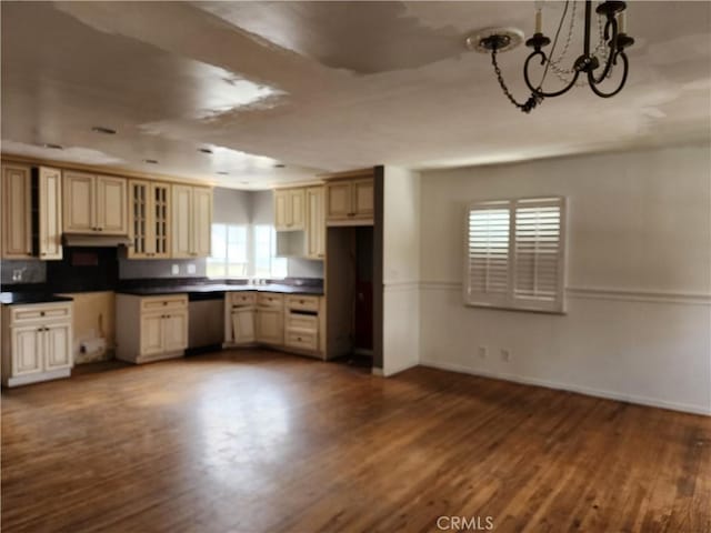 kitchen featuring dishwasher, cream cabinetry, and dark wood finished floors