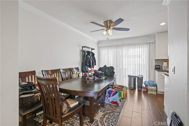 dining area featuring crown molding and ceiling fan