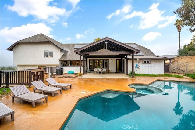 38680 Mesa Rd, Temecula, CA 92592 - back of property with solar panels, a patio area, a fenced backyard, a pool with connected hot tub, and roof with shingles
