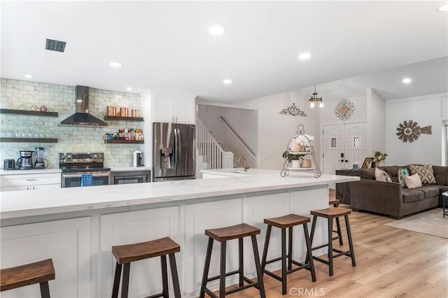 38680 Mesa Rd, Temecula, CA 92592 - kitchen with appliances with stainless steel finishes, wall chimney exhaust hood, backsplash, white cabinets, and open shelves