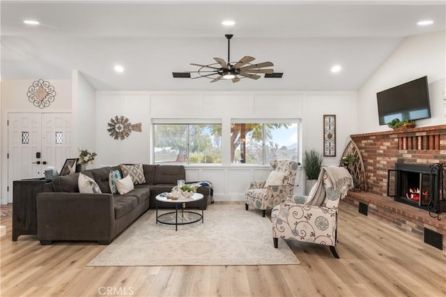 38680 Mesa Rd, Temecula, CA 92592 - living area featuring lofted ceiling, a brick fireplace, a ceiling fan, wood finished floors, and a decorative wall