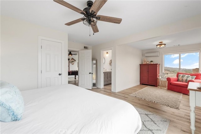 38680 Mesa Rd, Temecula, CA 92592 - bedroom featuring a wall unit AC, light wood-type flooring, ceiling fan, and ensuite bathroom