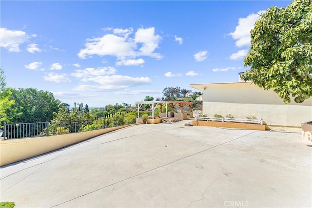 view of patio featuring fence