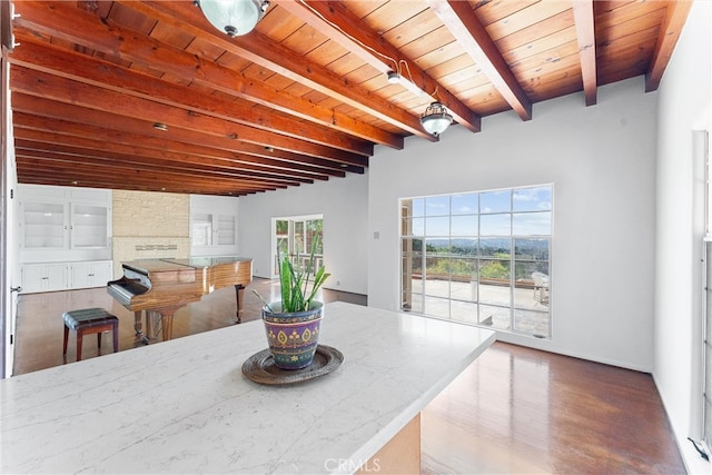 dining area featuring beamed ceiling and wooden ceiling