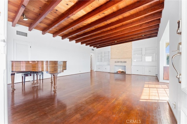 unfurnished living room with wood finished floors, visible vents, beam ceiling, wood ceiling, and a large fireplace