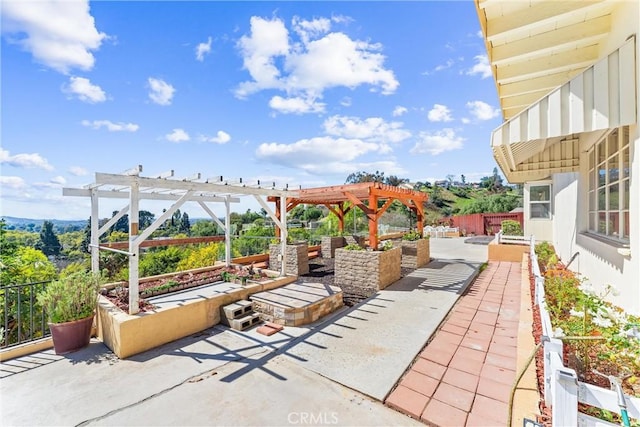 view of patio with a pergola and fence