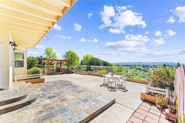 view of patio / terrace featuring outdoor dining space, a pergola, and fence