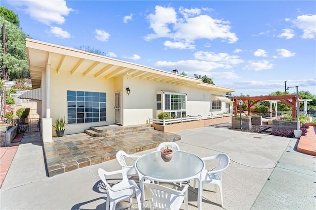 view of patio / terrace featuring a pergola and fence