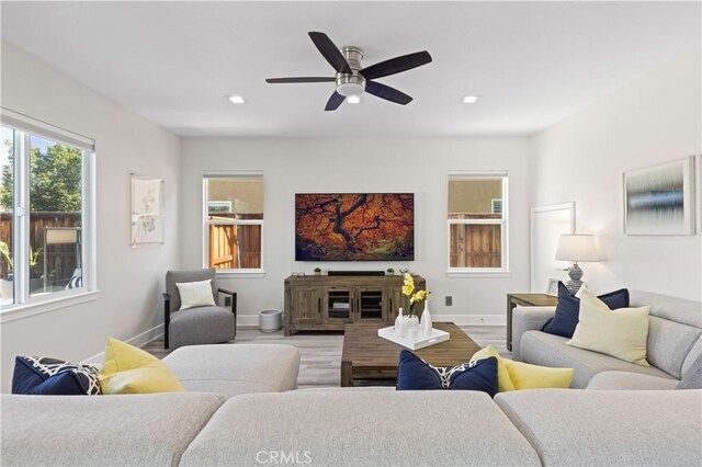 living room featuring recessed lighting, a ceiling fan, baseboards, and wood finished floors