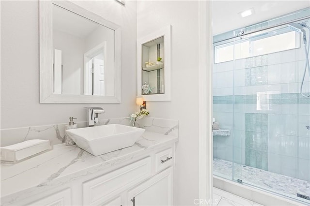 bathroom featuring a stall shower and vanity