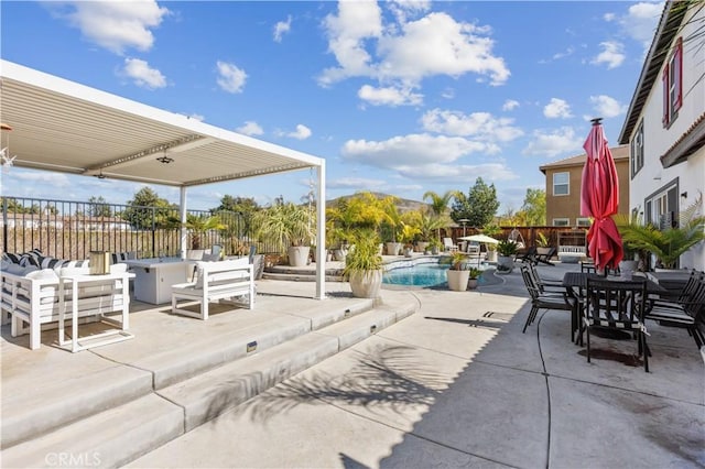 view of patio / terrace featuring an outdoor pool and fence