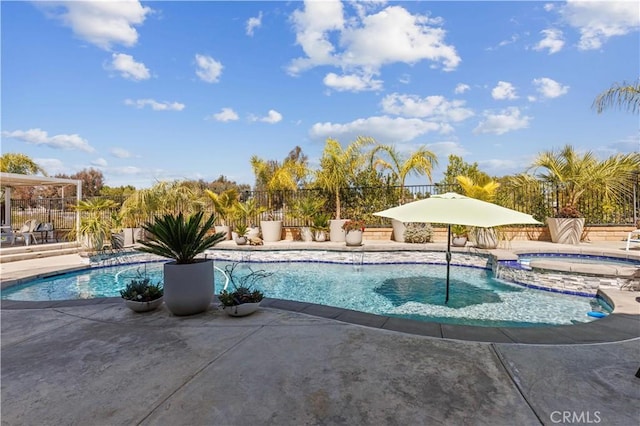 view of pool with an in ground hot tub, a fenced backyard, and a patio area