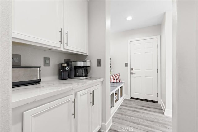 interior space with baseboards and light wood-style flooring