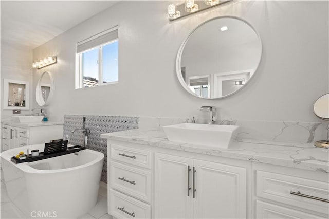 full bathroom with vanity and a freestanding bath