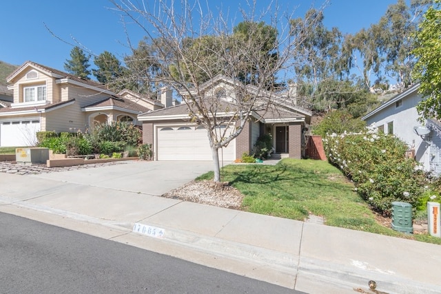 traditional home featuring a front yard, an attached garage, brick siding, and driveway